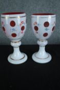 A pair of late 19th century Bohemian cameo glass goblets with hand painted floral decoration. H.20