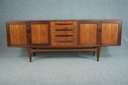 Sideboard, mid century teak by G-Plan with reinforced glass shelves. H.79 W.213 D.46cm.