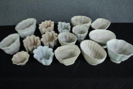 A collection of sixteen early 20th century stoneware and creamware jelly moulds of various