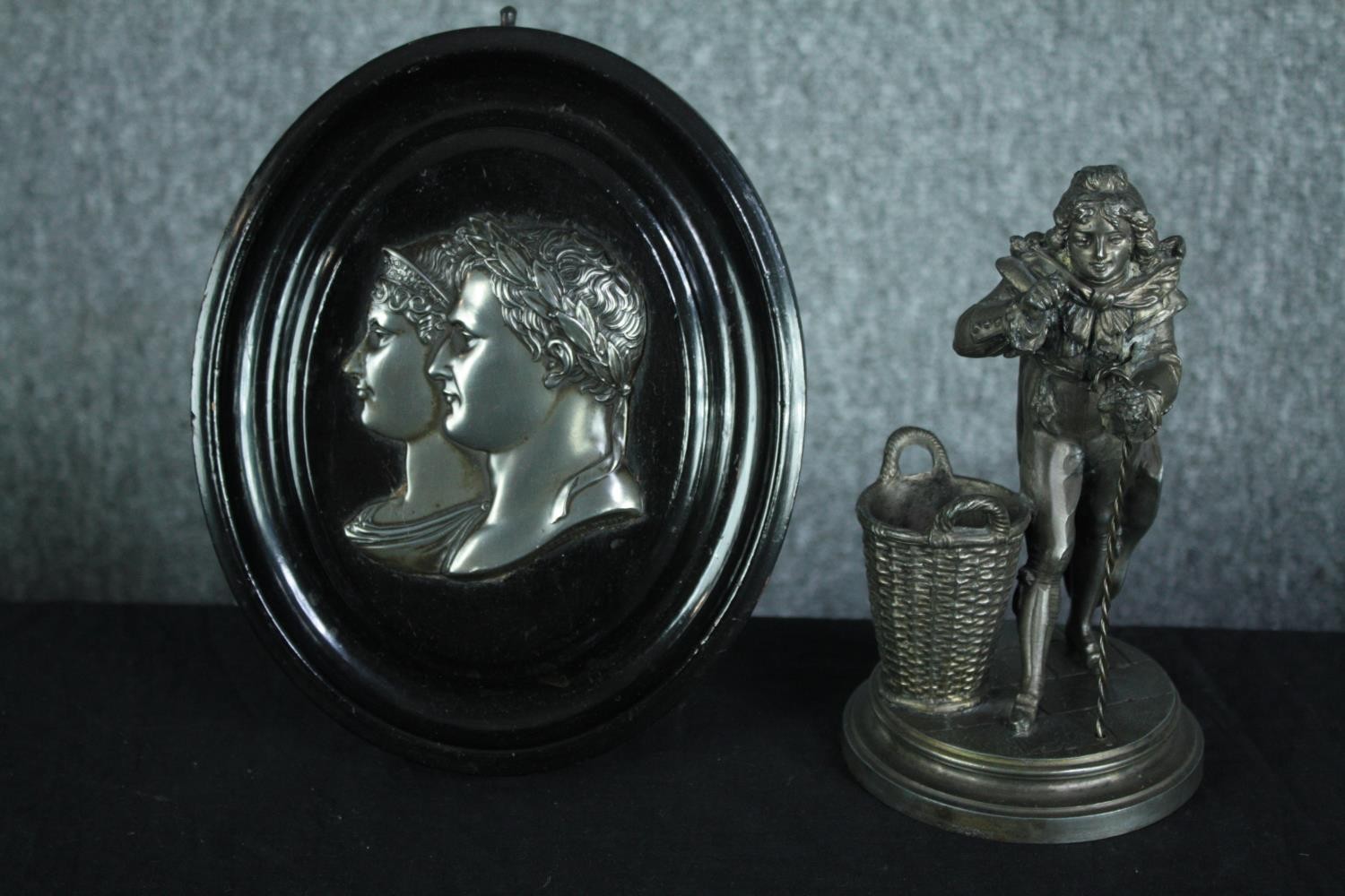 A mounted metal medallion of Emperor Napoleon Bonaparte and Josephine along with a figure in