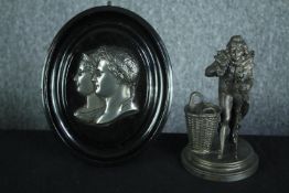 A mounted metal medallion of Emperor Napoleon Bonaparte and Josephine along with a figure in
