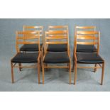 A set of six mid century vintage dining chairs in light beech and faux leather seats.