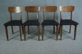 Dining chairs, a set of four contemporary teak in a mid century style.
