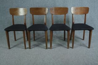 Dining chairs, a set of four contemporary teak in a mid century style.