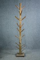 A hall coat and hatstand cut from a hardwood branch. Lacquered finish. H.202cm.