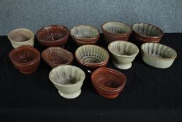 A collection of twelve early 20th century stoneware jelly moulds of various designs, some with a
