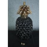 A 1970s vintage ceramic pineapple lamp finished in gilt. A part of the base is loose and in need