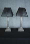 A pair of metal table lamps with matching shades, Corinthian column on stepped bases. H.54 cm (each)