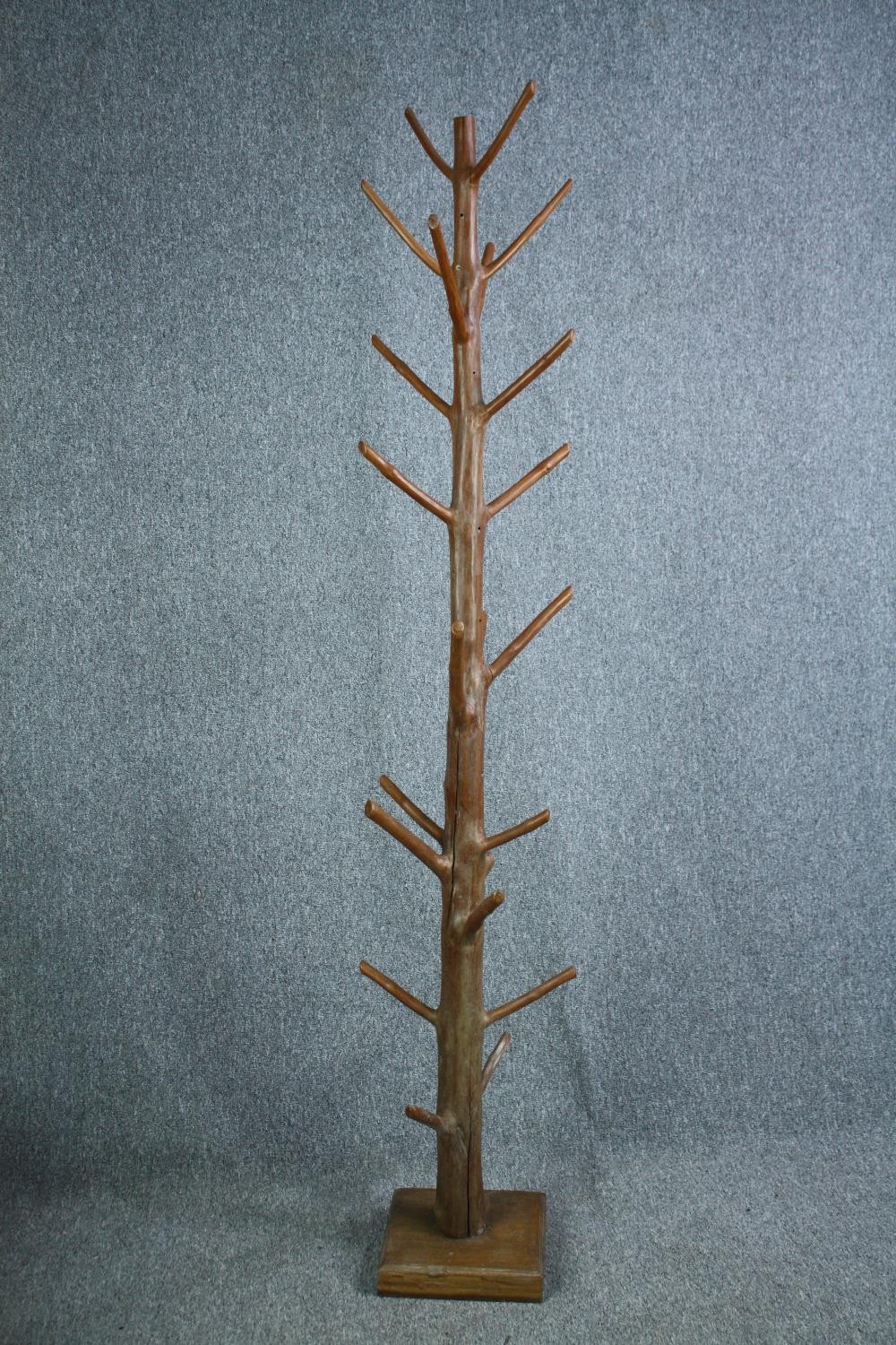A hall coat and hatstand cut from a hardwood branch. Lacquered finish. H.205cm.