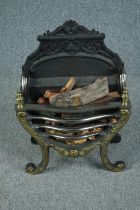 A heavy Regency style cast iron and brass fire grate. H.65 W.48 D.25 cm.