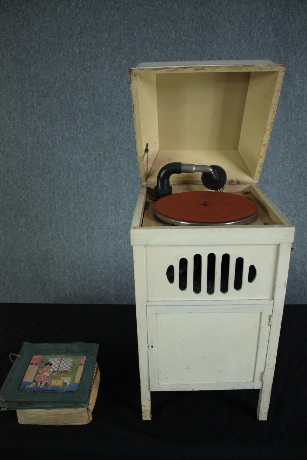 A children's or nursery gramophone record player with a collection of nursery rhyme records. 78 rpm.