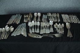 A large mixed collection of silver plated cutlery. Spoons, knives and forks, and a cake server. L.