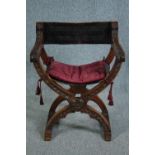 A C.1900 Continental x frame walnut folding armchair with leather seat and back. H.82cm.