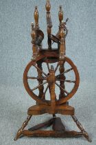 A 19th century elm and ash upright spinning wheel. H.91 W.50cm.