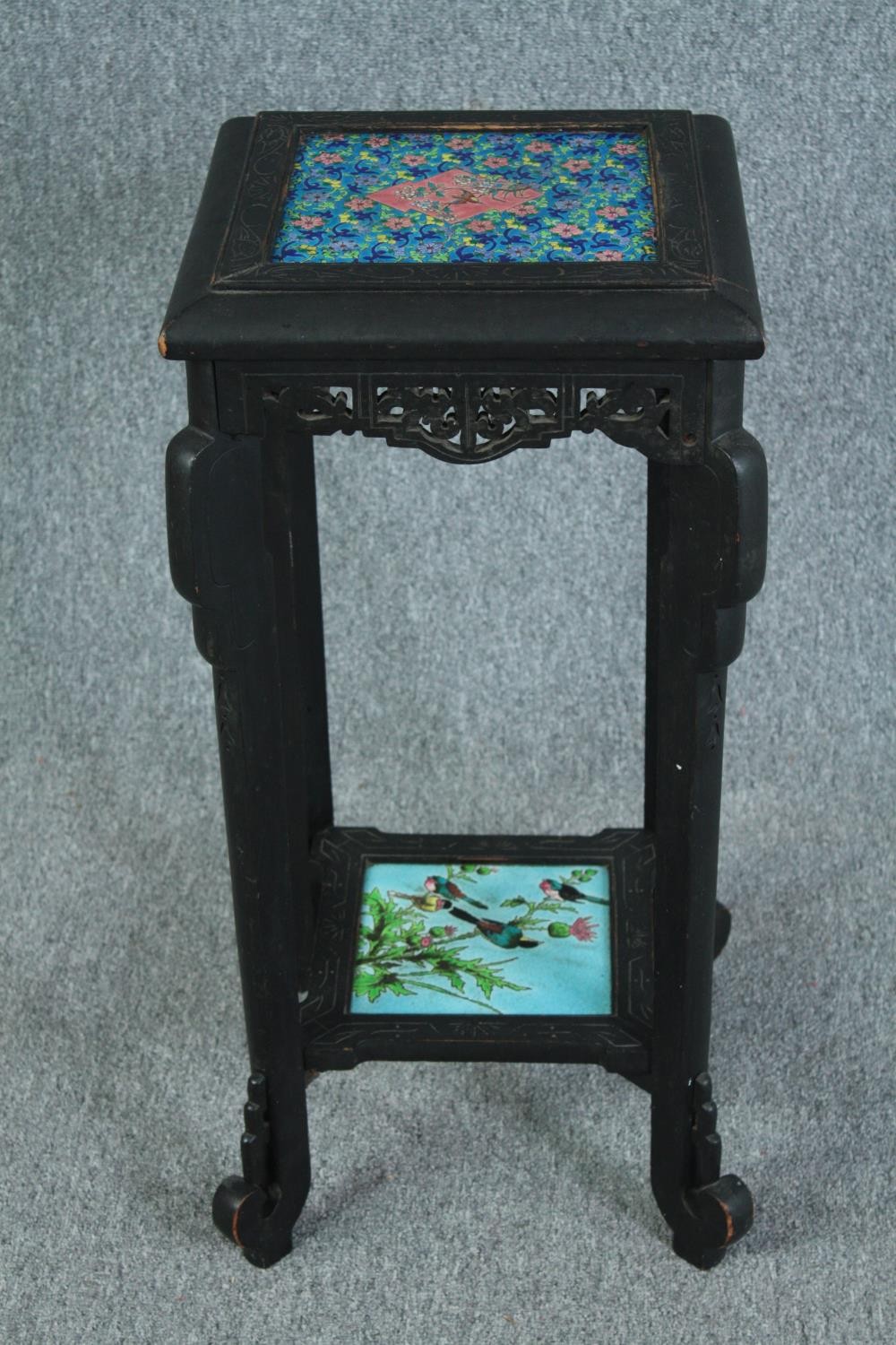 A late 19th century Chinese hardwood jardiniere stand with inset tiles to the top and undertier. H.