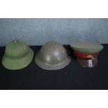 Two military helmets and a Russian officers soft cap. The Brody helmet maybe made in South Africa