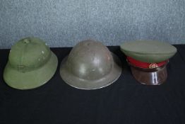 Two military helmets and a Russian officers soft cap. The Brody helmet maybe made in South Africa