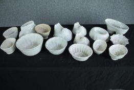 A collection of fifteen early 20th century stoneware and creamware jelly moulds of various