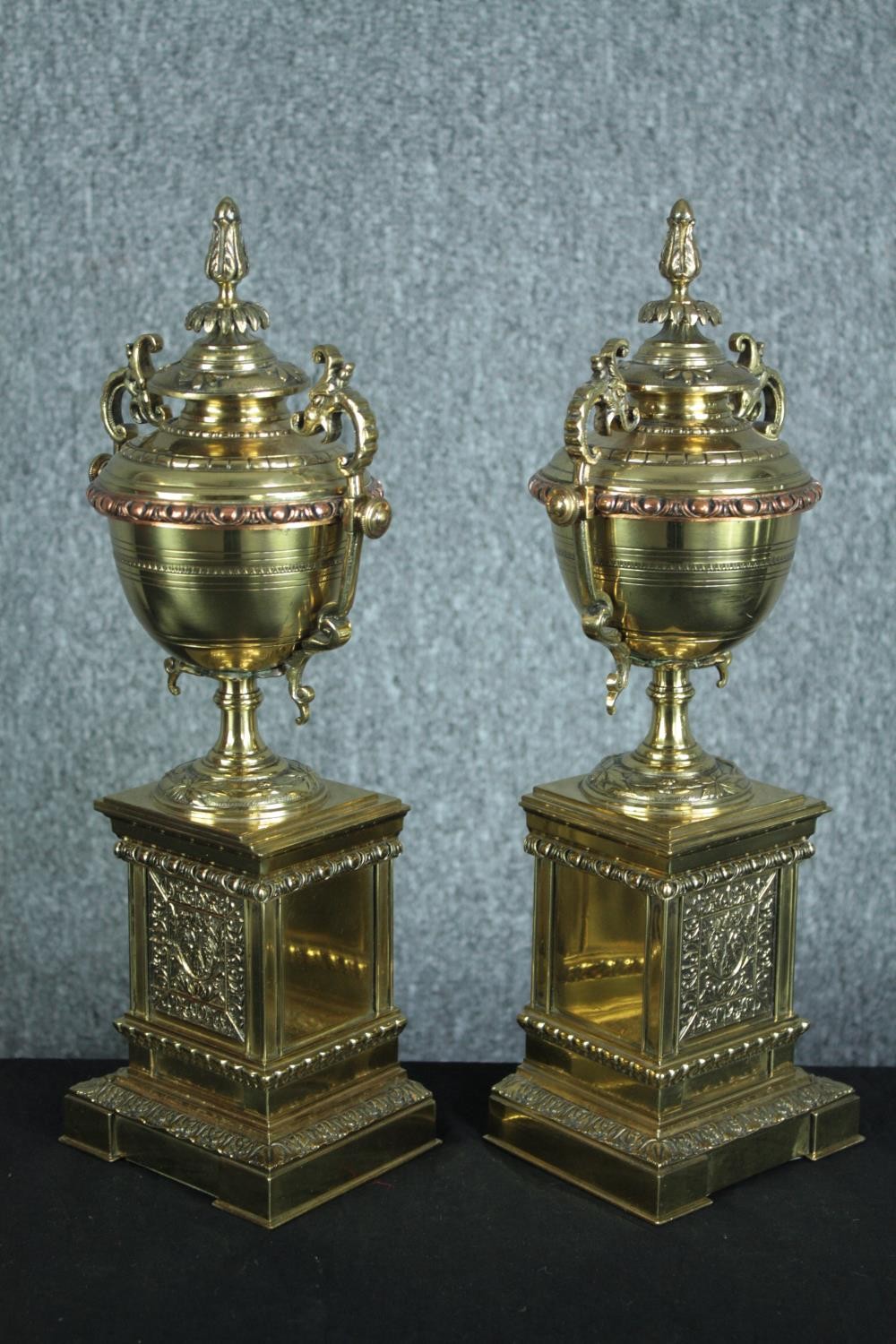 A pair of early 20th century brass and copper classical design twin handled urns on weighted - Image 2 of 7