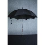 A vintage black silk parasol with hallmarked silver handle and maker's label. L.92cm.