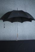 A vintage black silk parasol with hallmarked silver handle and maker's label. L.92cm.
