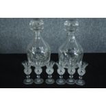 A matching pair of decanters and six small ornate sherry glasses. Twentieth century. H.24cm. (