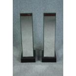 A pair of mirrored pedestals with hinged doors and storage shelves. H.74 W.25cm.