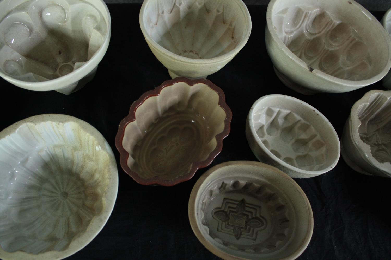 A collection of fifteen early 20th century stoneware and creamware jelly moulds of various - Image 5 of 5