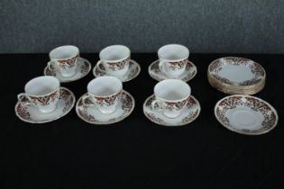 A Colclough six person coffee set with stylised floral design and gilded edging. Dia.15cm. (largest)