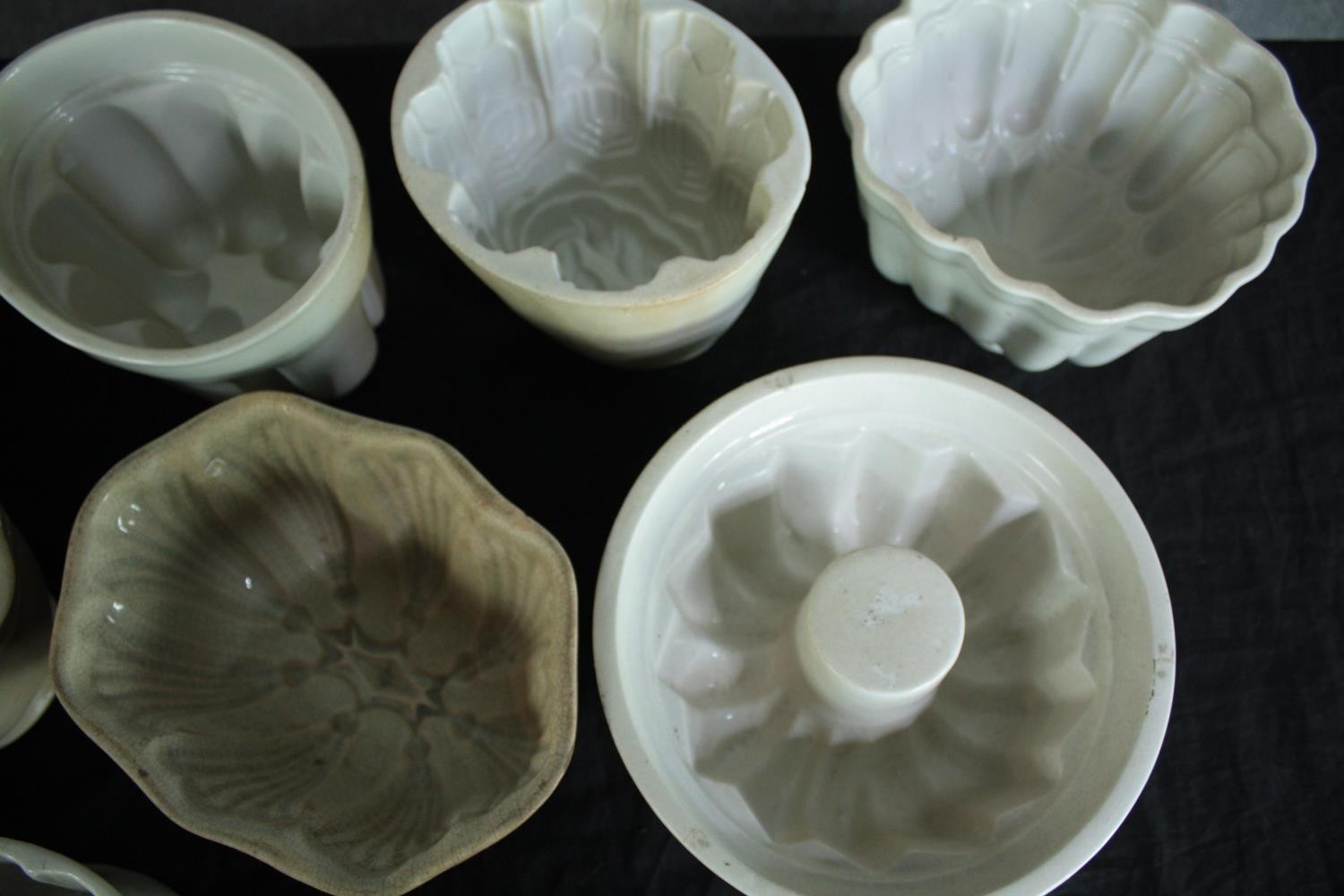 A collection of fifteen early 20th century stoneware and creamware jelly moulds of various - Image 3 of 5