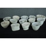 A collection of thirteen early 20th century stoneware and creamware jelly moulds of various designs.