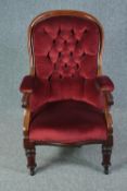 Library armchair, mid 19th century mahogany framed in deep buttoned upholstery. H.102cm.