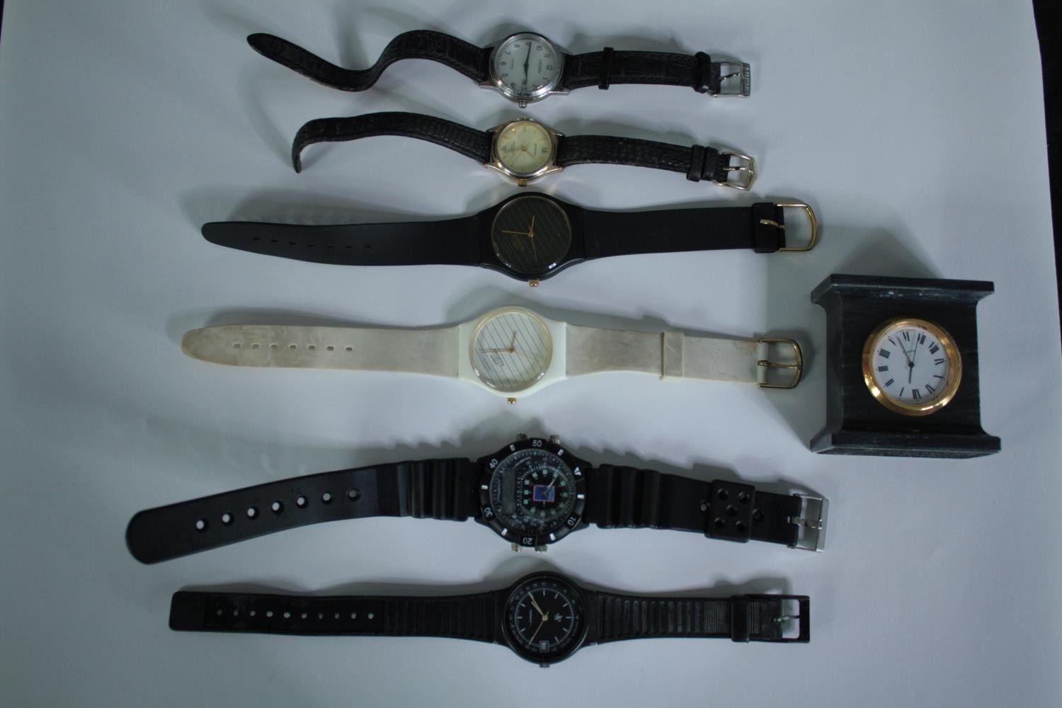 A collection of watches and a small mantel clock. H.6 W.6 D.3cm.