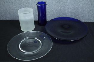 Two studio glass vases and two plates. One bearing the legend 'D&S 6.9.97'. Dia.39cm. (largest)