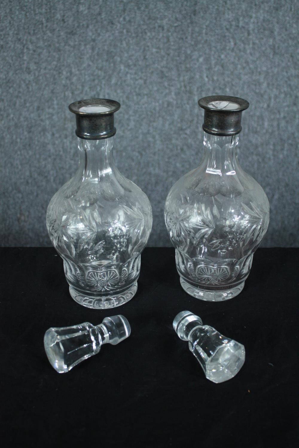 A pair of cut crystal decanters with vine decoration and fitted with silver collars. Hallmarked: - Image 4 of 7