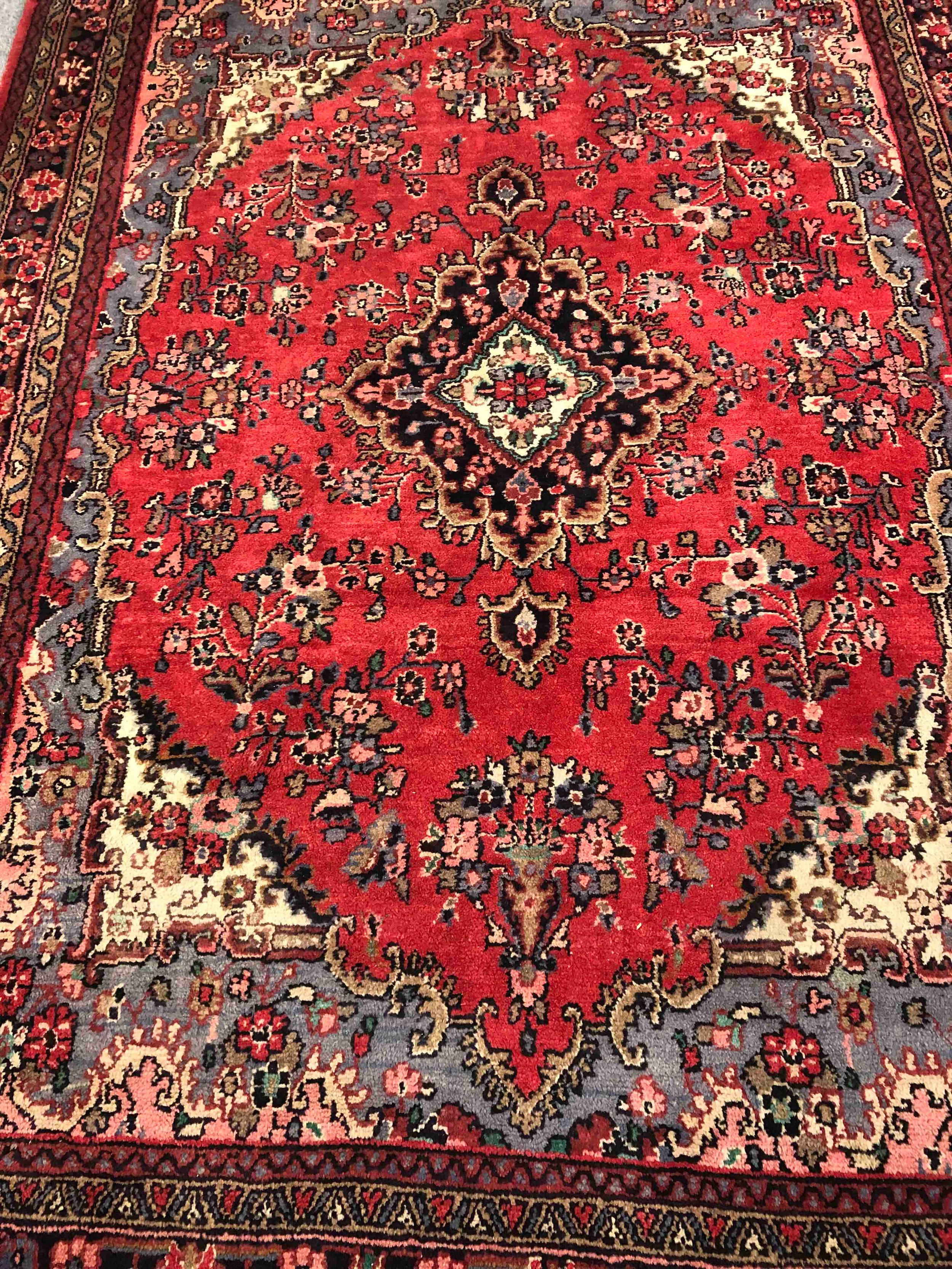 A Persian Sarouk carpet with central medallion and flowerhead motifs across the burgundy field - Image 2 of 3