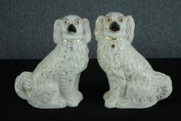 A pair of Staffordshire porcelain Spaniels with matching coats and glass eyes. H.30cm. (each)