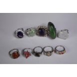 A collection of ten silver gem-set rings of various designs. Set with orange sapphire, Turquoise,