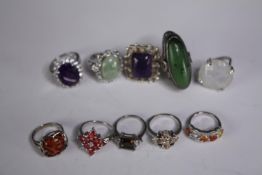 A collection of ten silver gem-set rings of various designs. Set with orange sapphire, Turquoise,