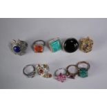 A collection of ten silver gem-set rings of various designs. Set with Blue topaz, Turquoise,