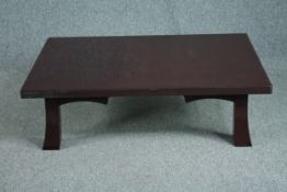 A Japanese style lacquered coffee table. H.30 W.105 D.76cm. (Some damage as shown).