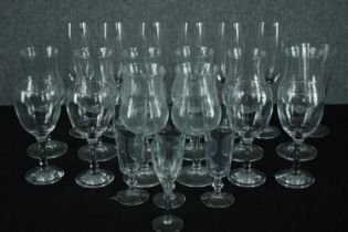 A mixed collection of stemmed glasses. In sets of eight, six, and three with a single sherry