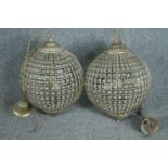 A pair of spherical beaded crystal glass and metal pendant light fittings. H.70cm.