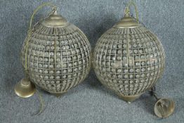 A pair of spherical beaded crystal glass and metal pendant light fittings. H.70cm.