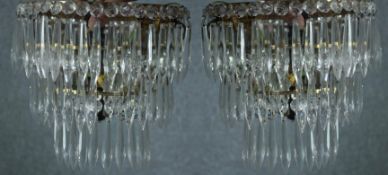 A pair of mirror backed crystal wall lights. Decorated with hanging teardrop glass. H.23 cm. (each)