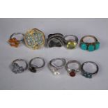 A collection of ten silver gem-set rings of various designs. Set with Fire opal, Turquoise,