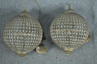 A pair of spherical beaded crystal glass and metal light fittings. H.70 cm.