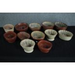 A collection of twelve early 20th century stoneware jelly moulds of various designs, some with a
