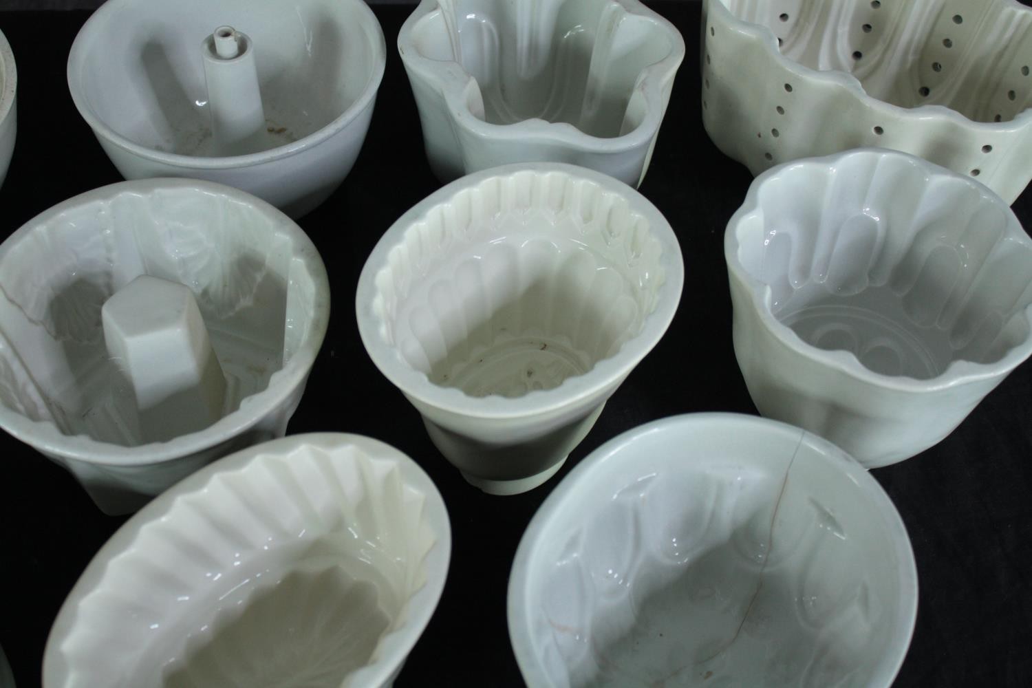 A collection of thirteen early 20th century stoneware and creamware jelly moulds of various designs. - Image 4 of 4