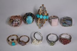 A collection of ten silver gem-set rings of various designs. Set with rose quartz, Turquoise,